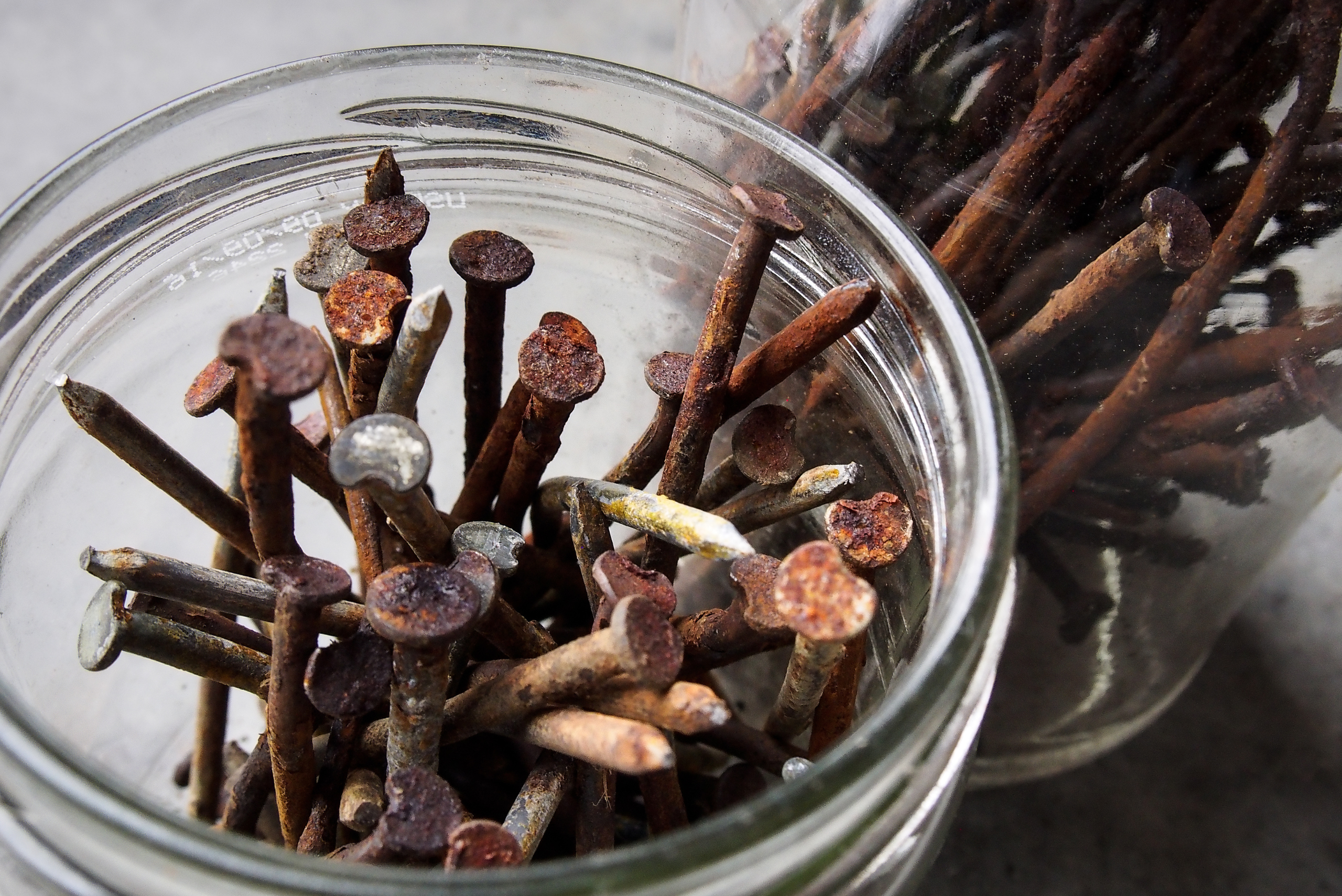 Rusty nail in a glass jar