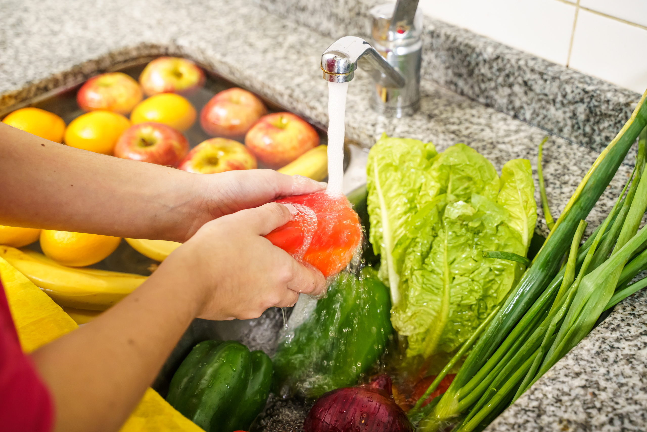 Person waking fruit and vegetables.