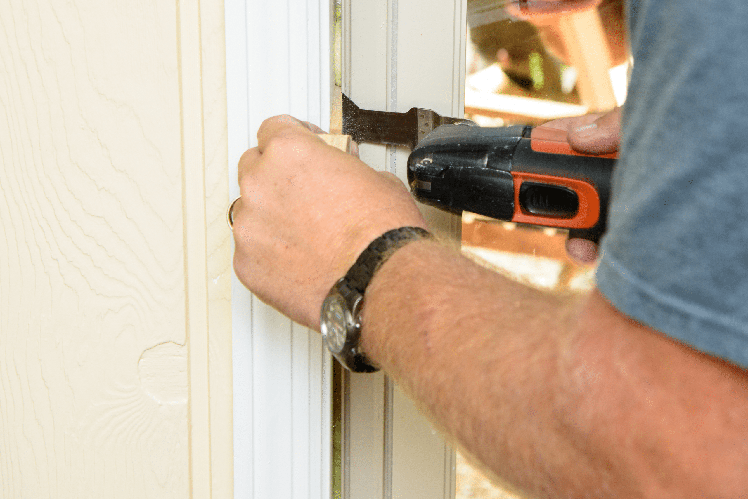 Oscillating tool being used on a door frame.