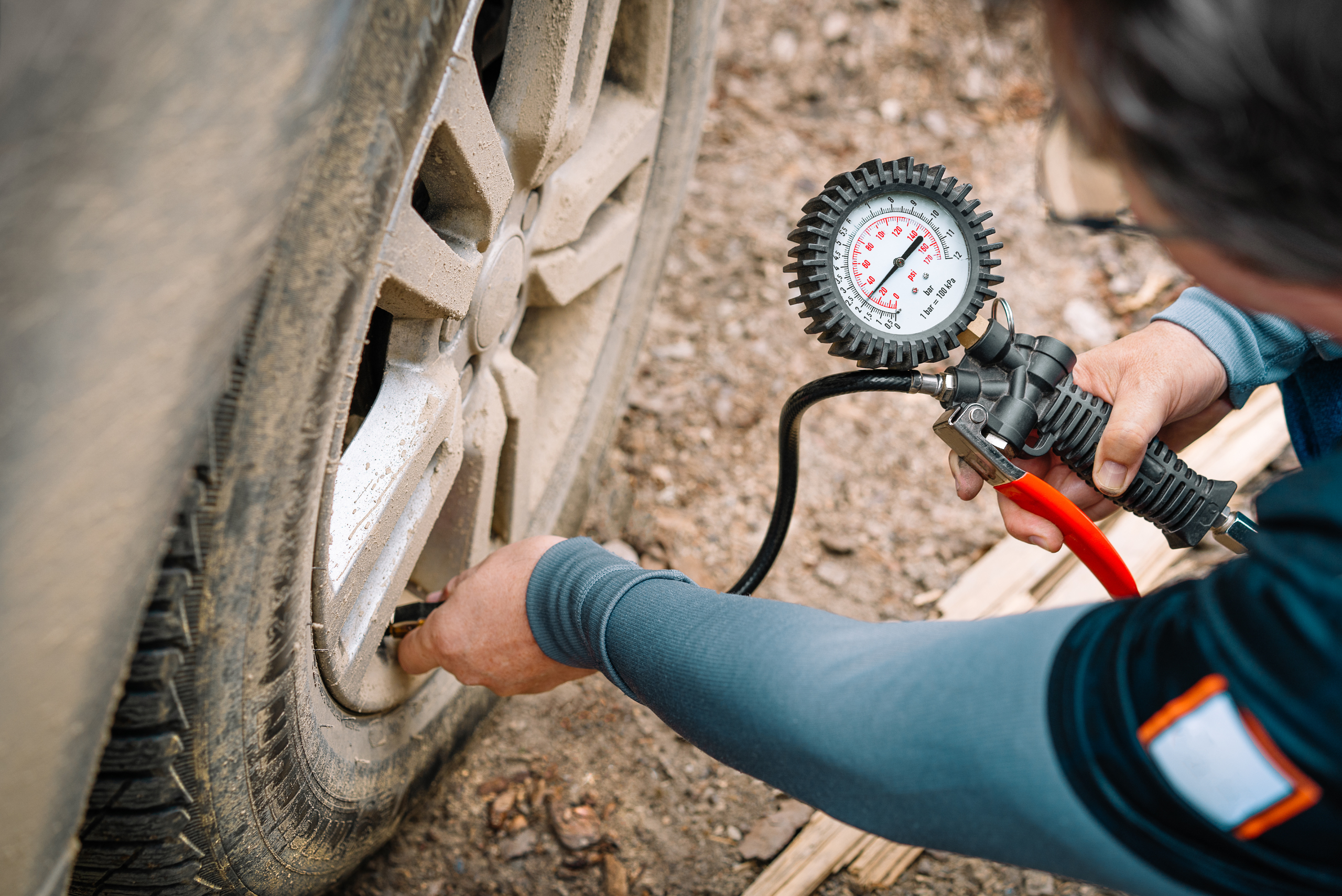 Adding air to tire.