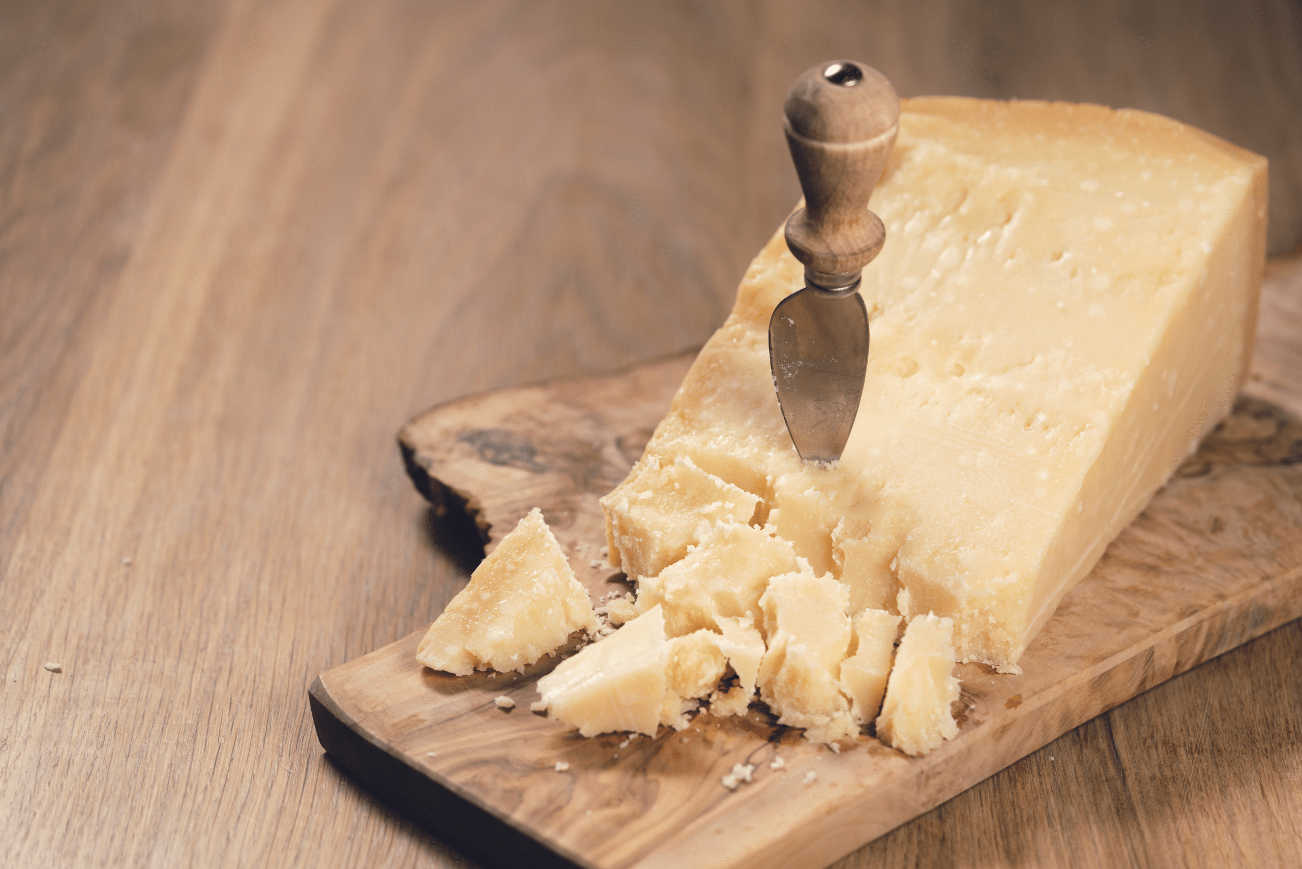 Parmesan cheese with knife stuck into it