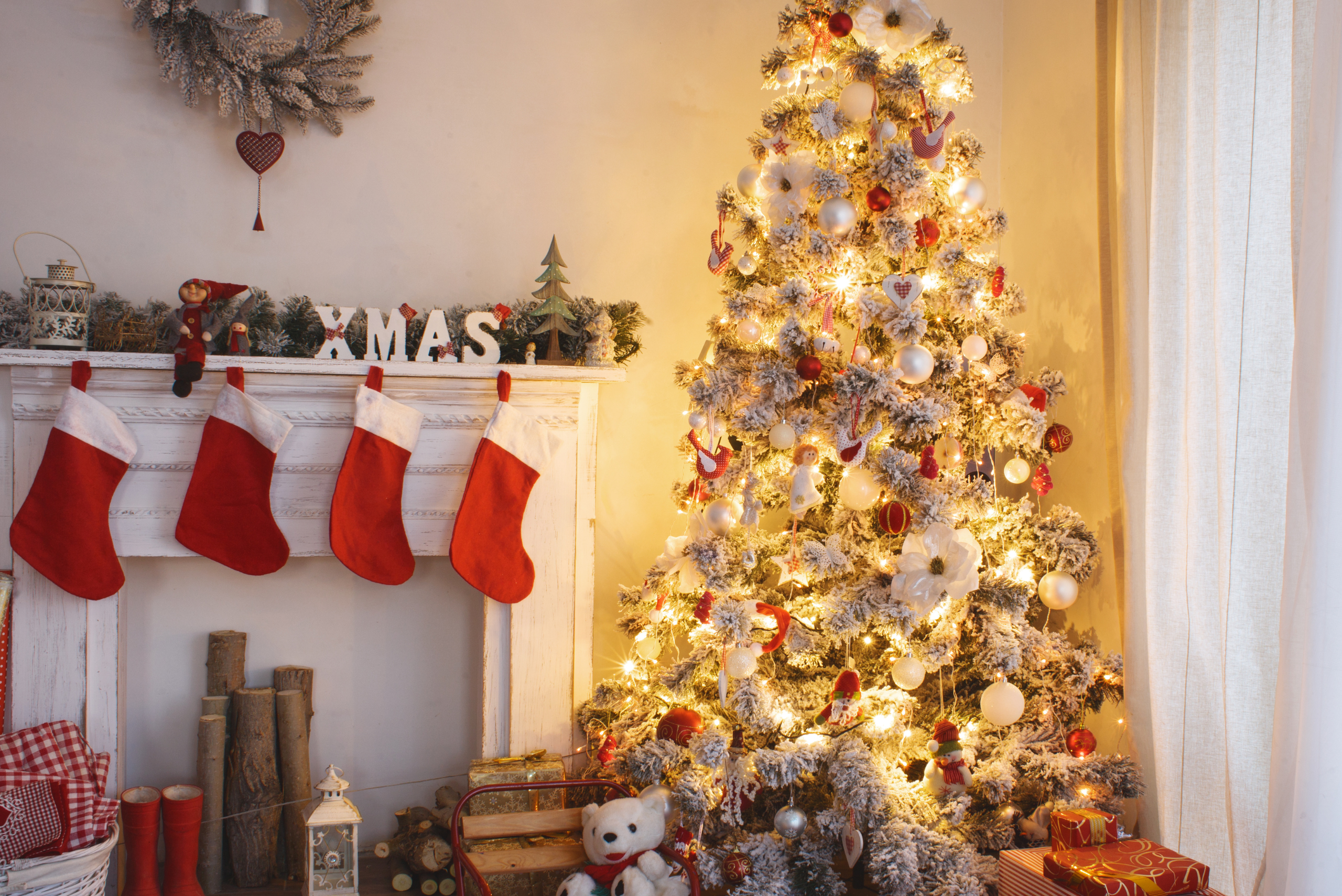 Lit up Christmas tree in a living room of a house.