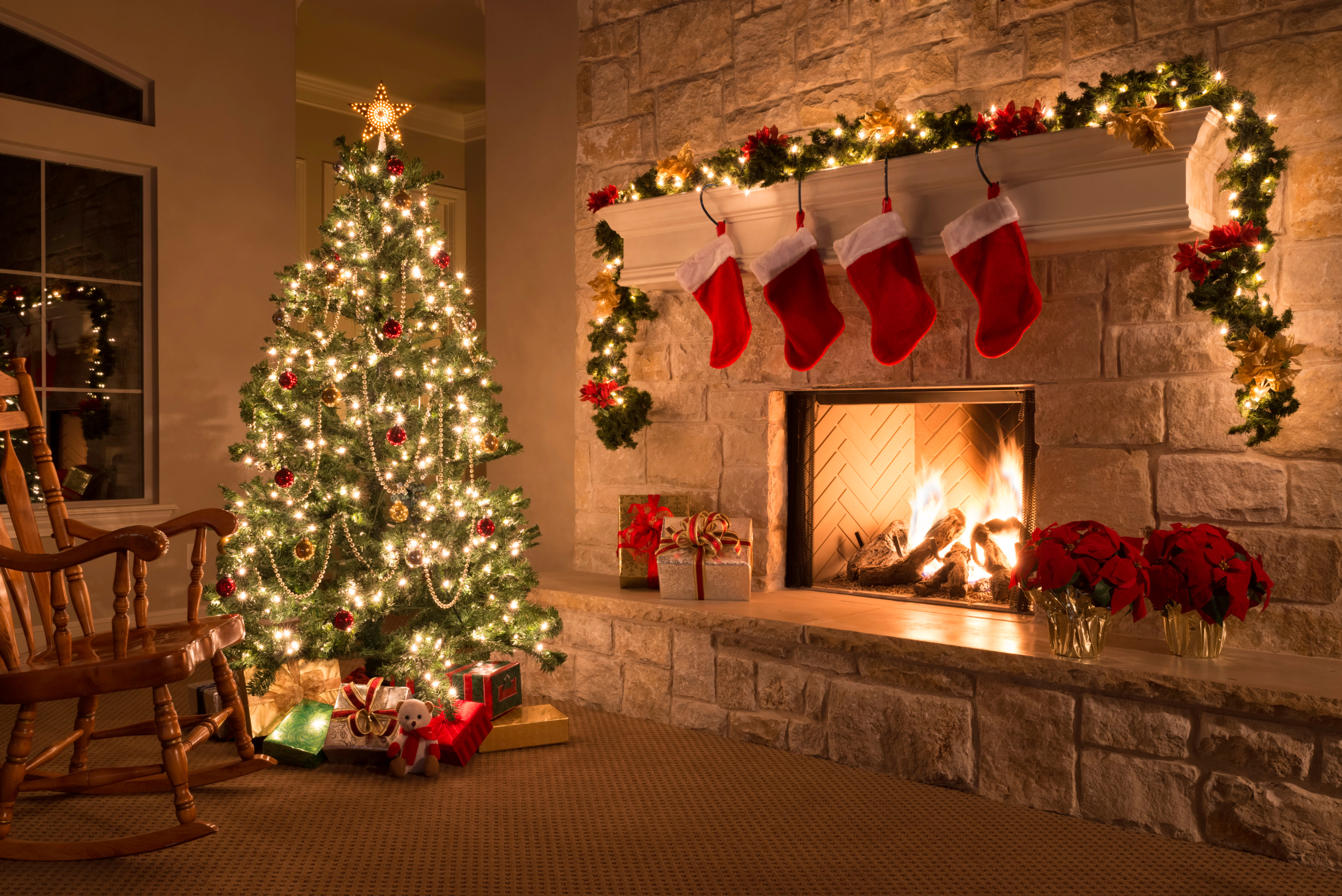 Lit up Christmas tree in a living room of a house.