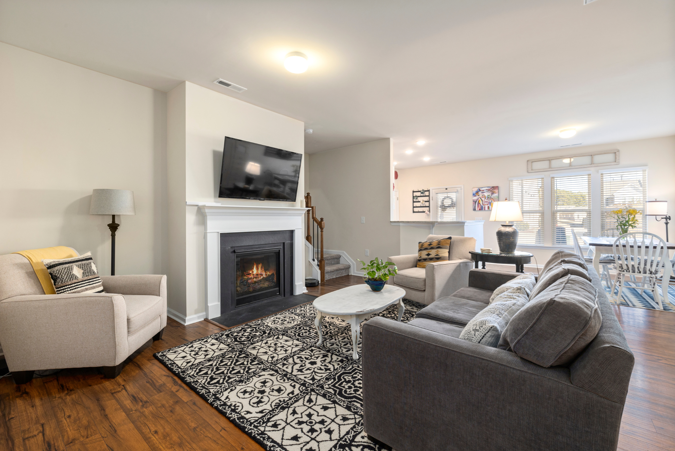 TV mounted above fireplace in a modern living room.