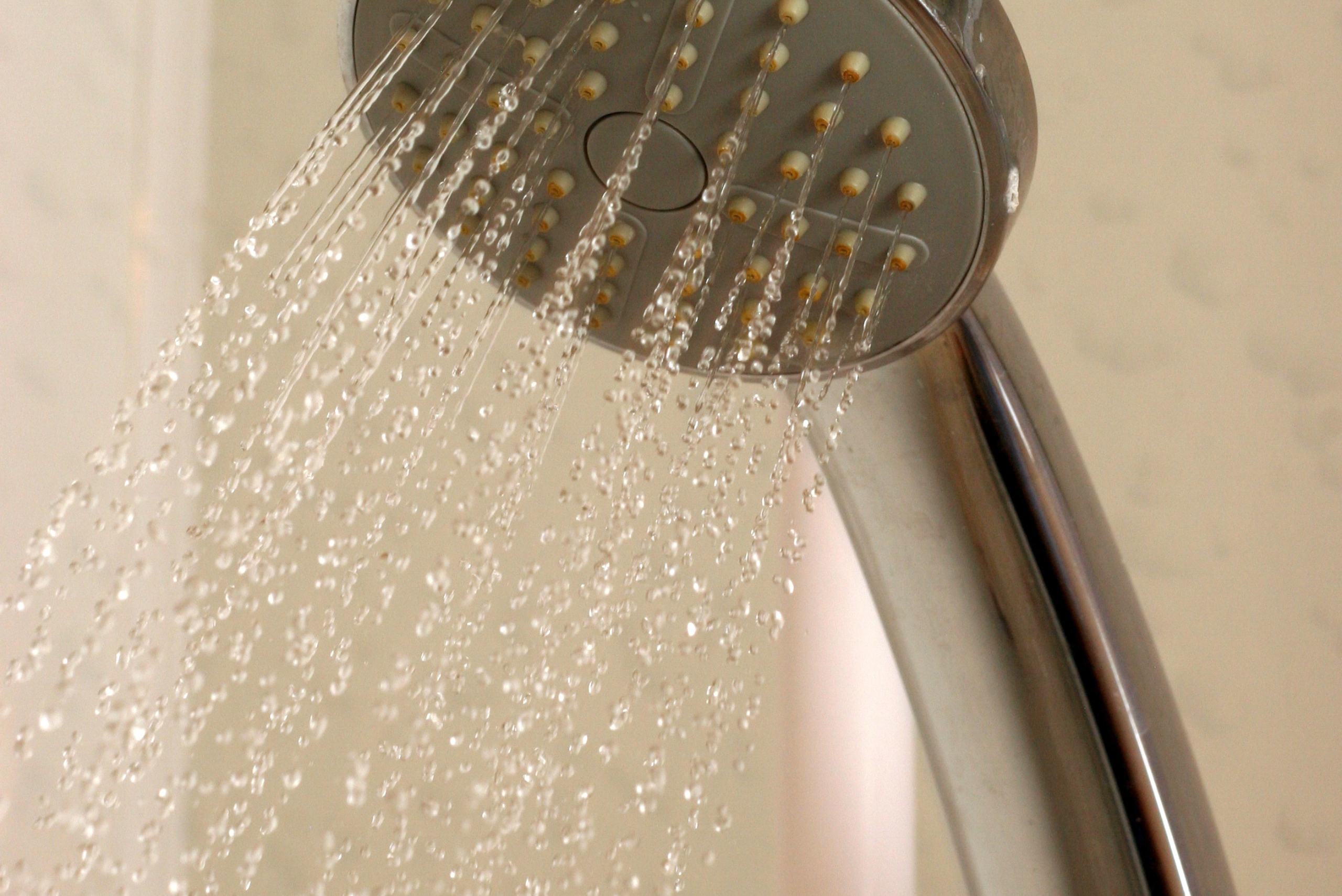 Shower head with water coming out.