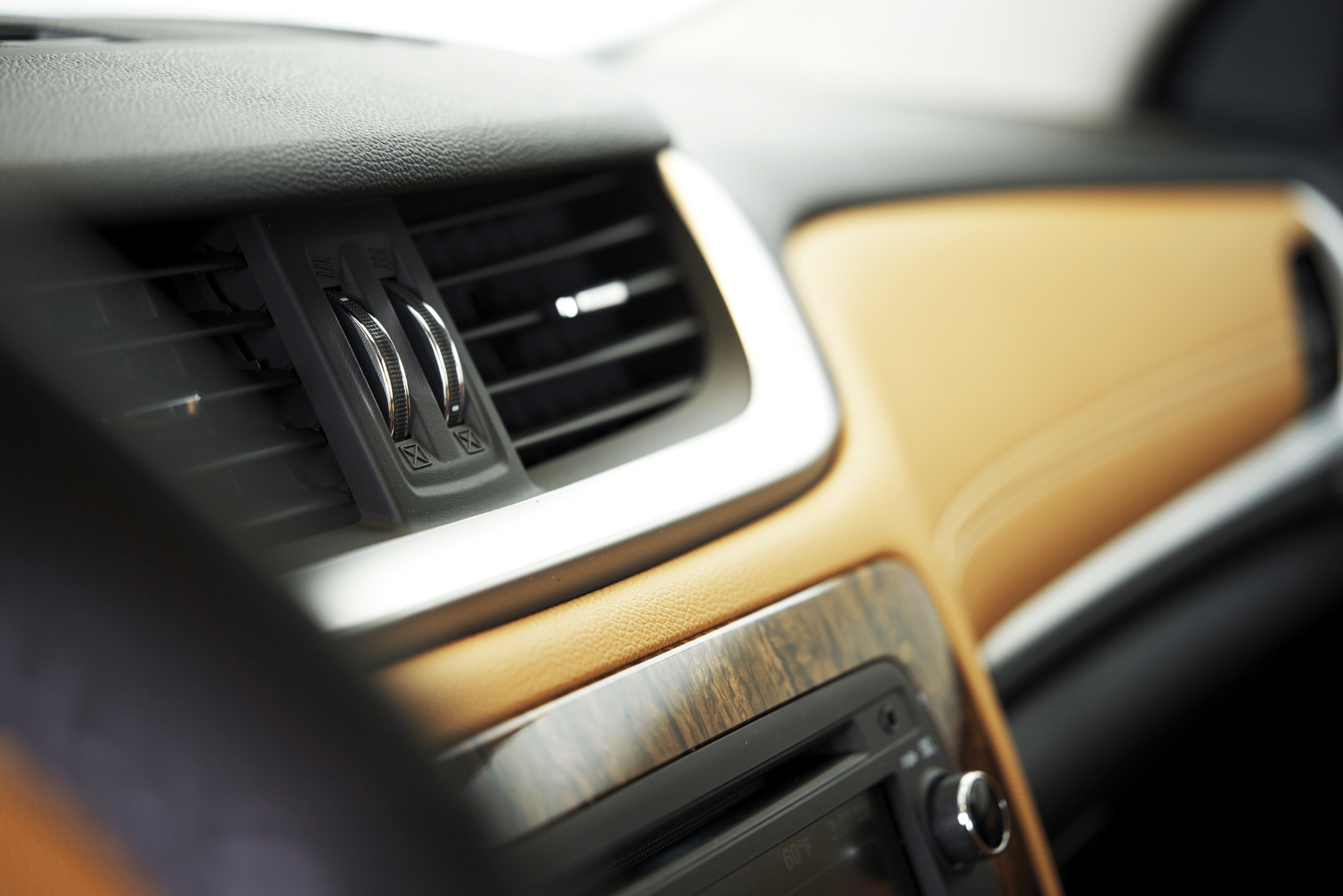 Closeup of car interior air vents.