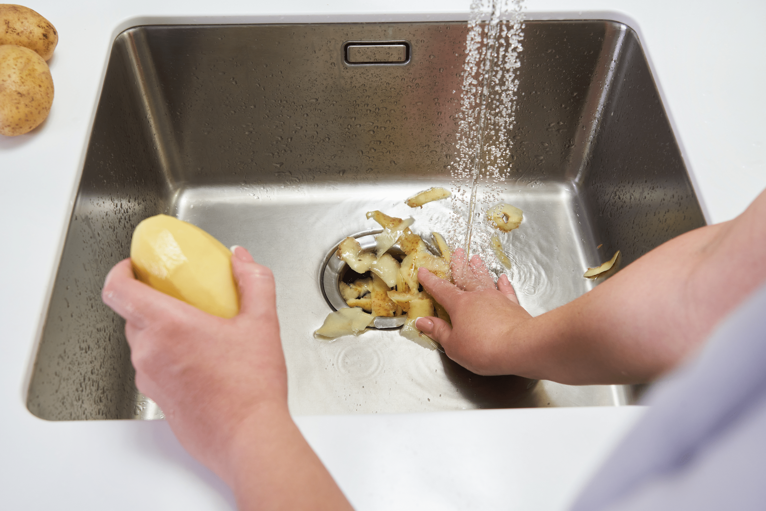 Putting potato peels down the garbage disposal. 