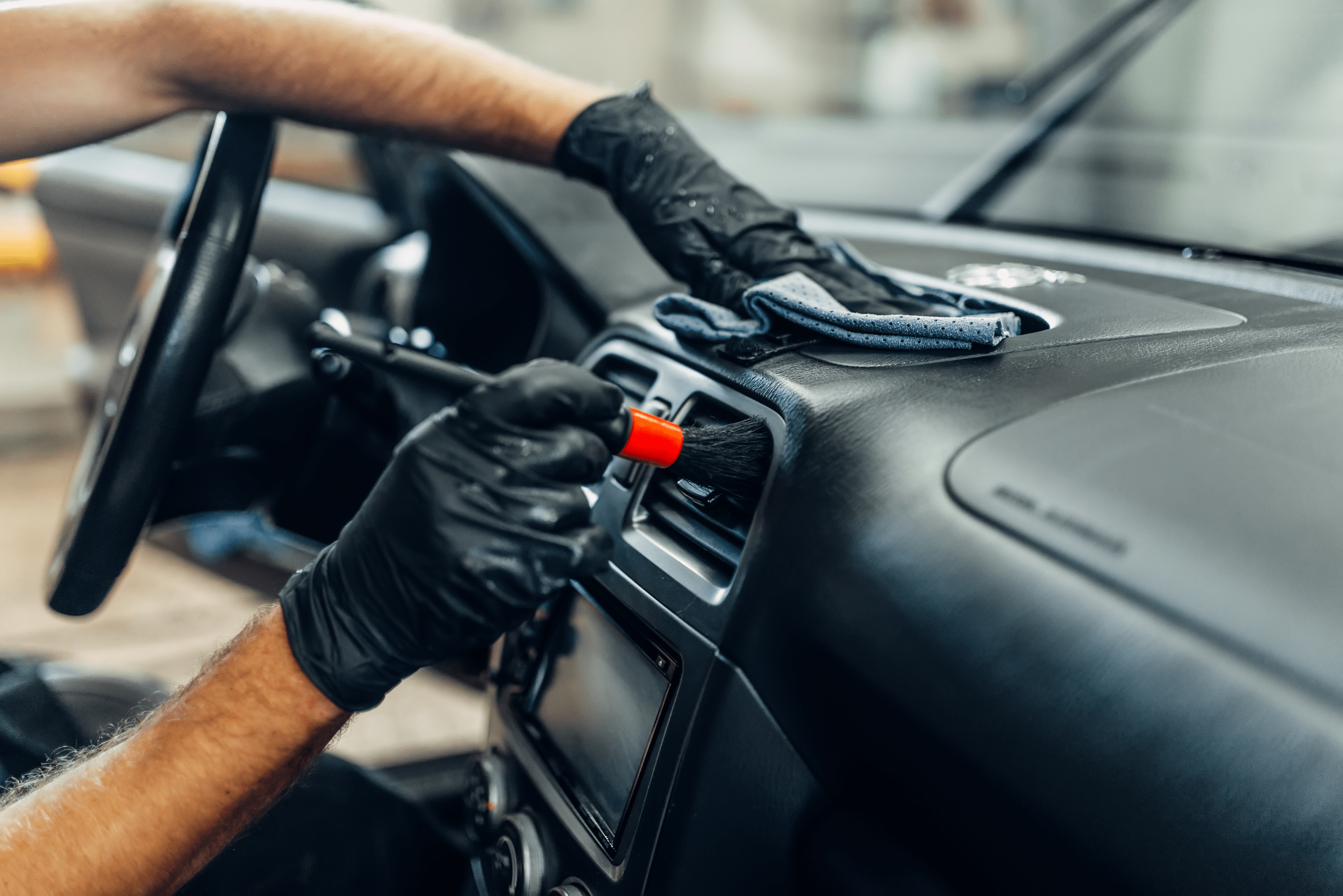 Cleaning a car's dashboard.