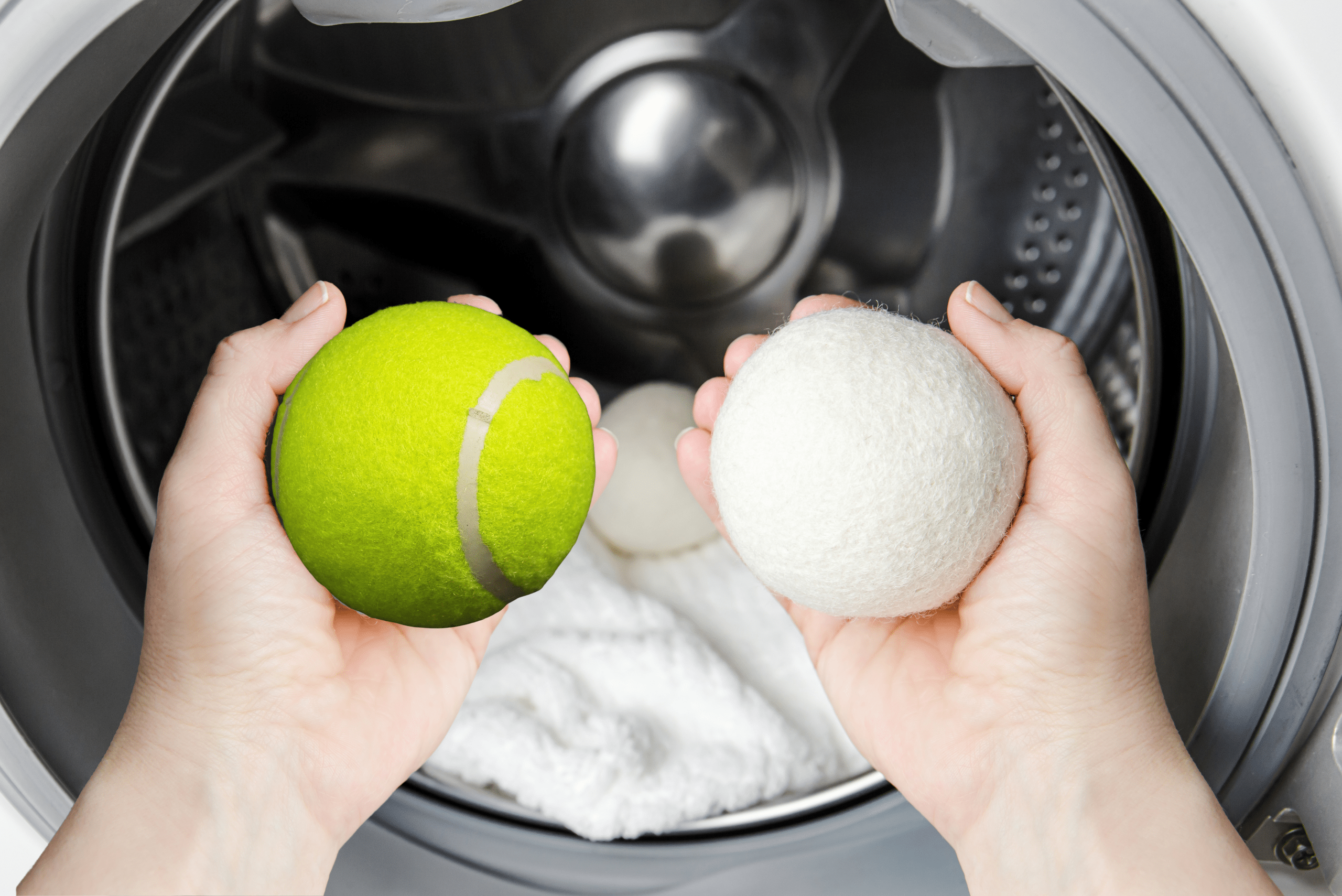 Two hands in front of dryer, one holding a tennis ball, the other a dryer ball.