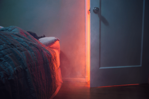 Fire outside of a bedroom door.