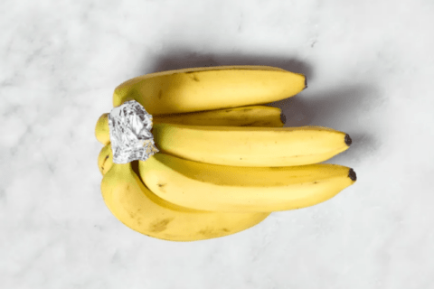 Tin foil wrapped on a bunch of bananas.