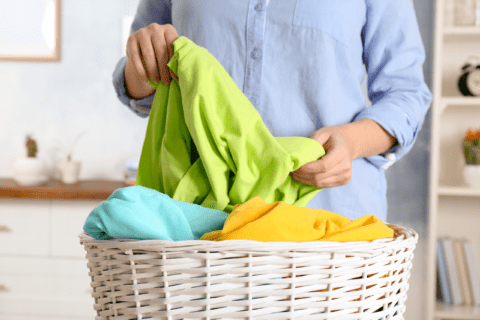 Person sorting through their laundry basket.