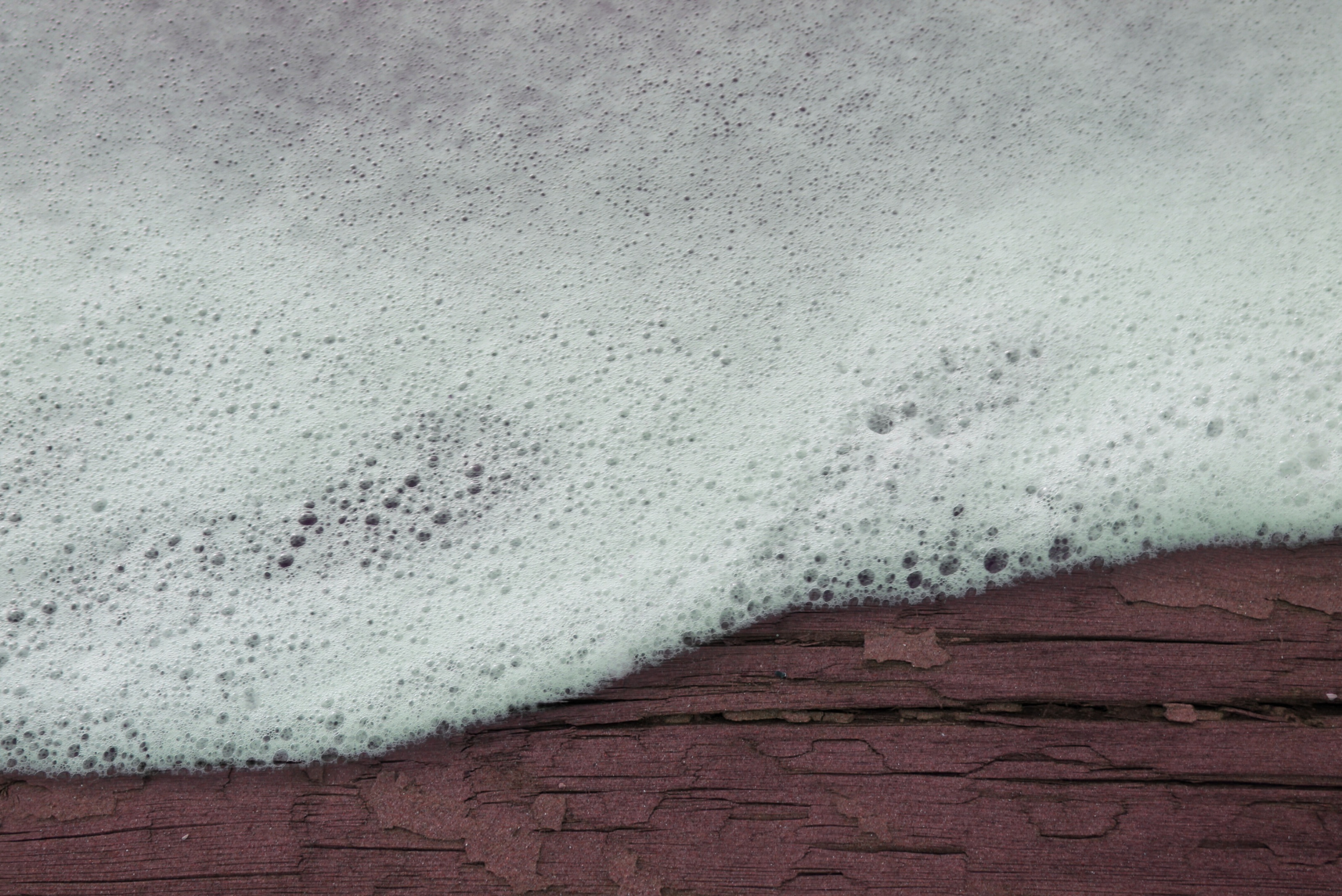 Soapy water on wooden floor.