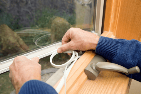 Sealing window gap using weatherstripping.