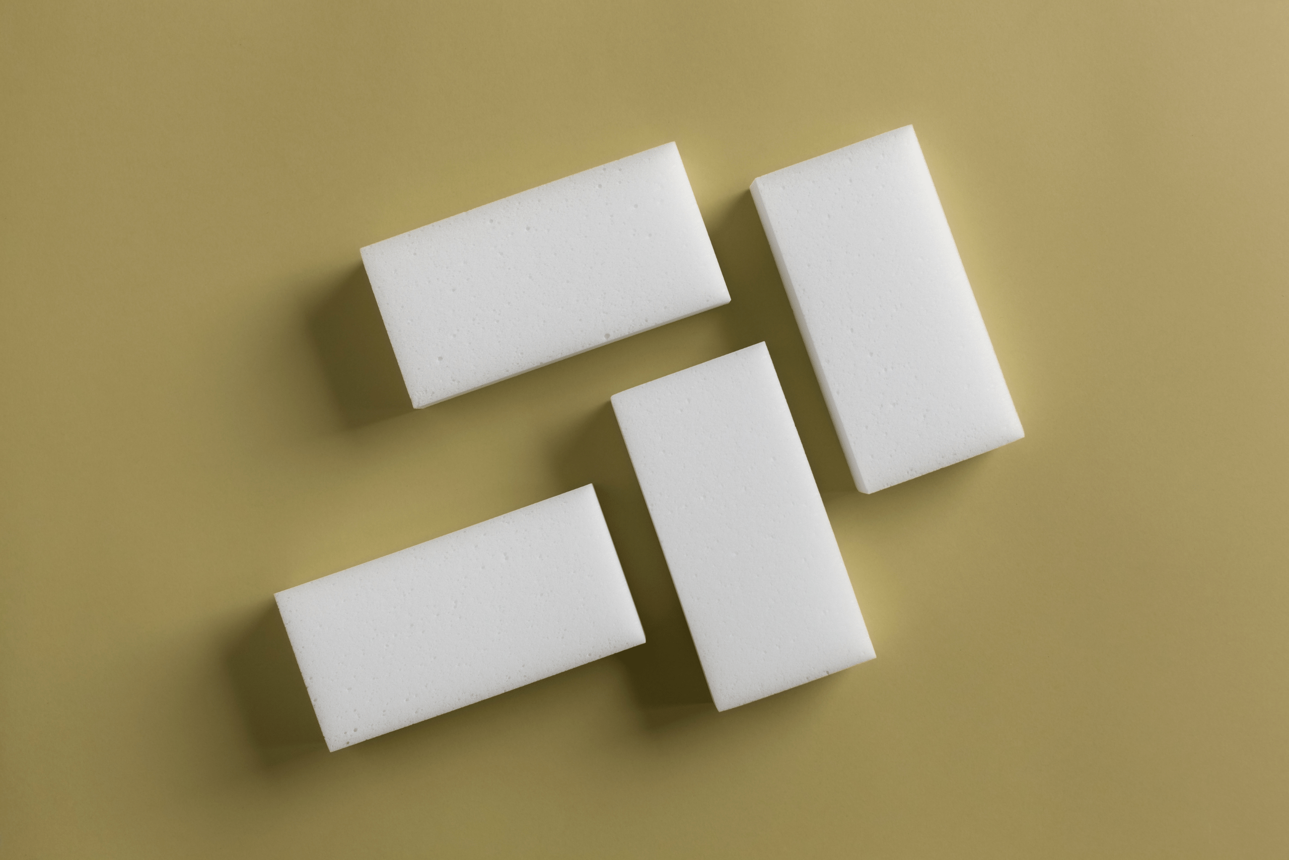 Four white magic eraser sponges.