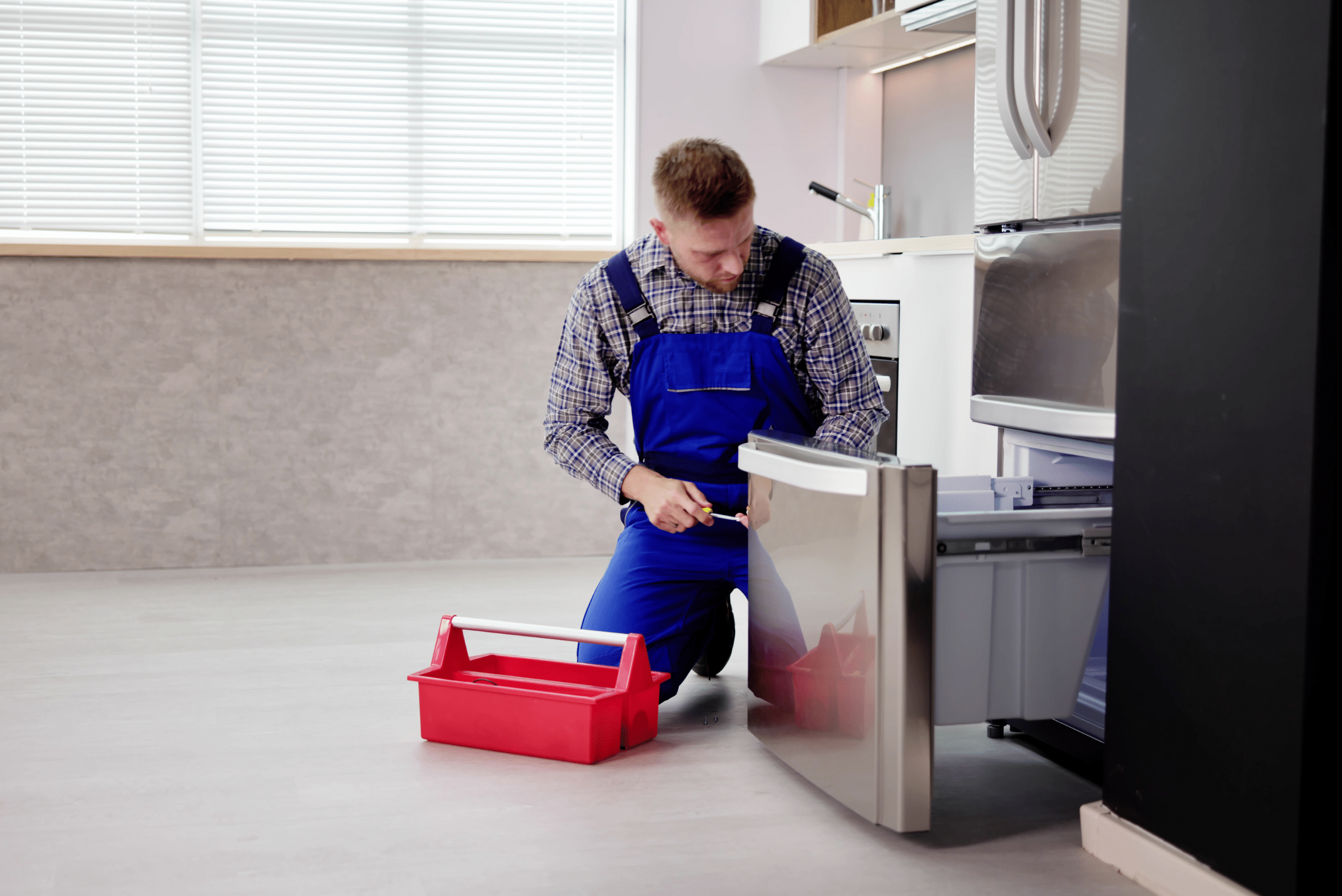 Worker fixing fridge.