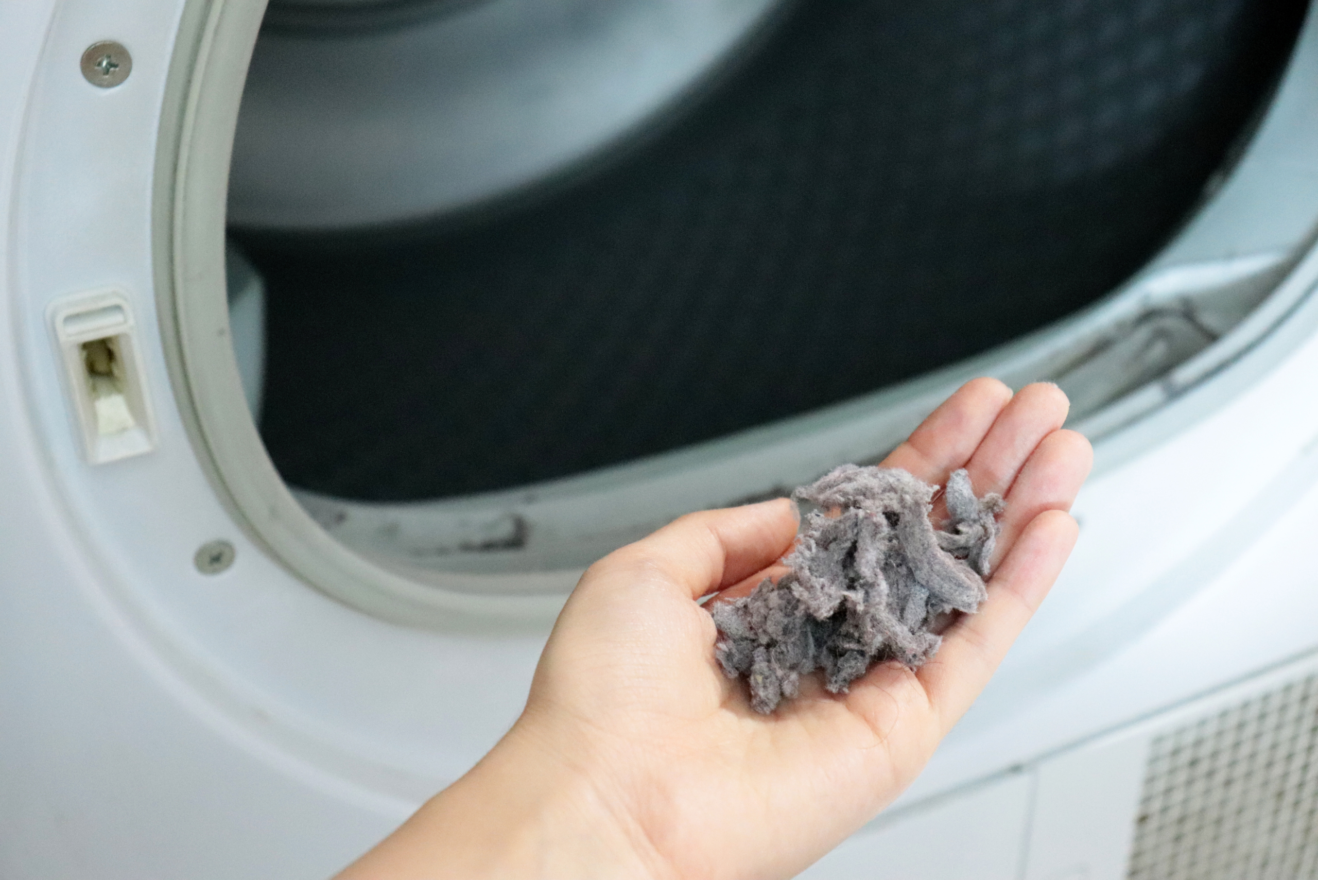 Person holding lint in their hand.