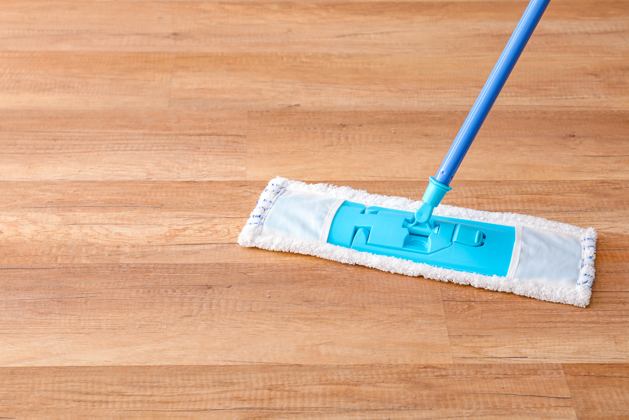 Microfiber mop on wooden floor.