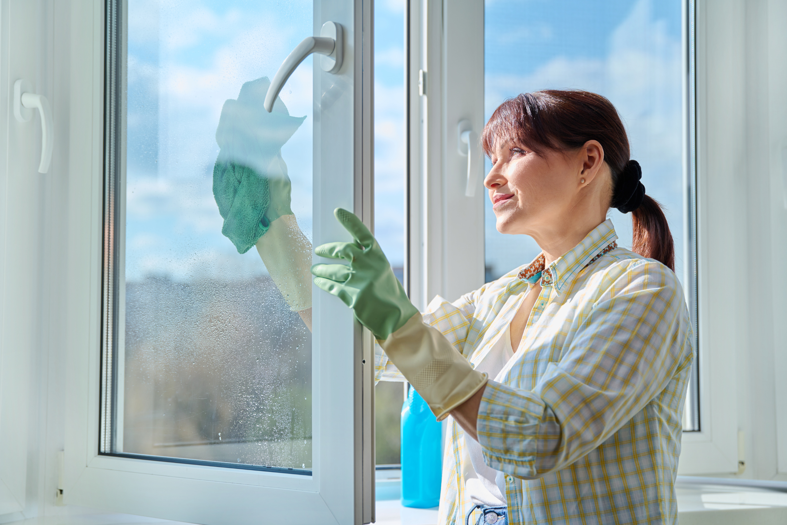 Woman cleaning window.