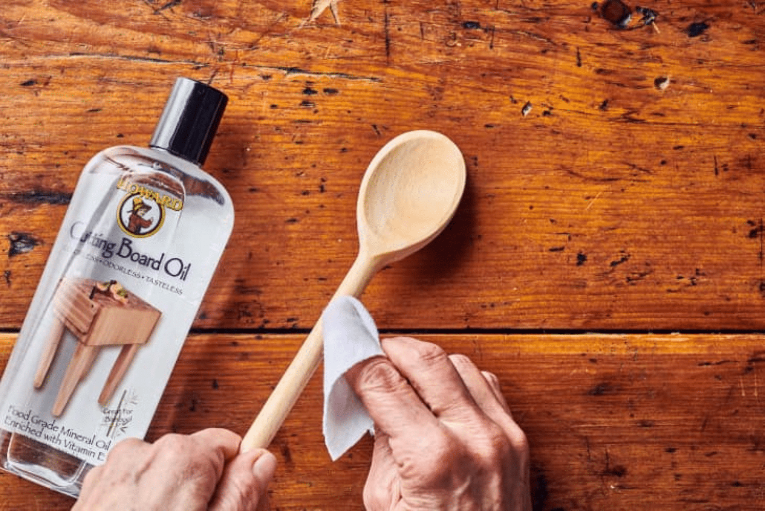 Staining wooden spoon with mineral oil.