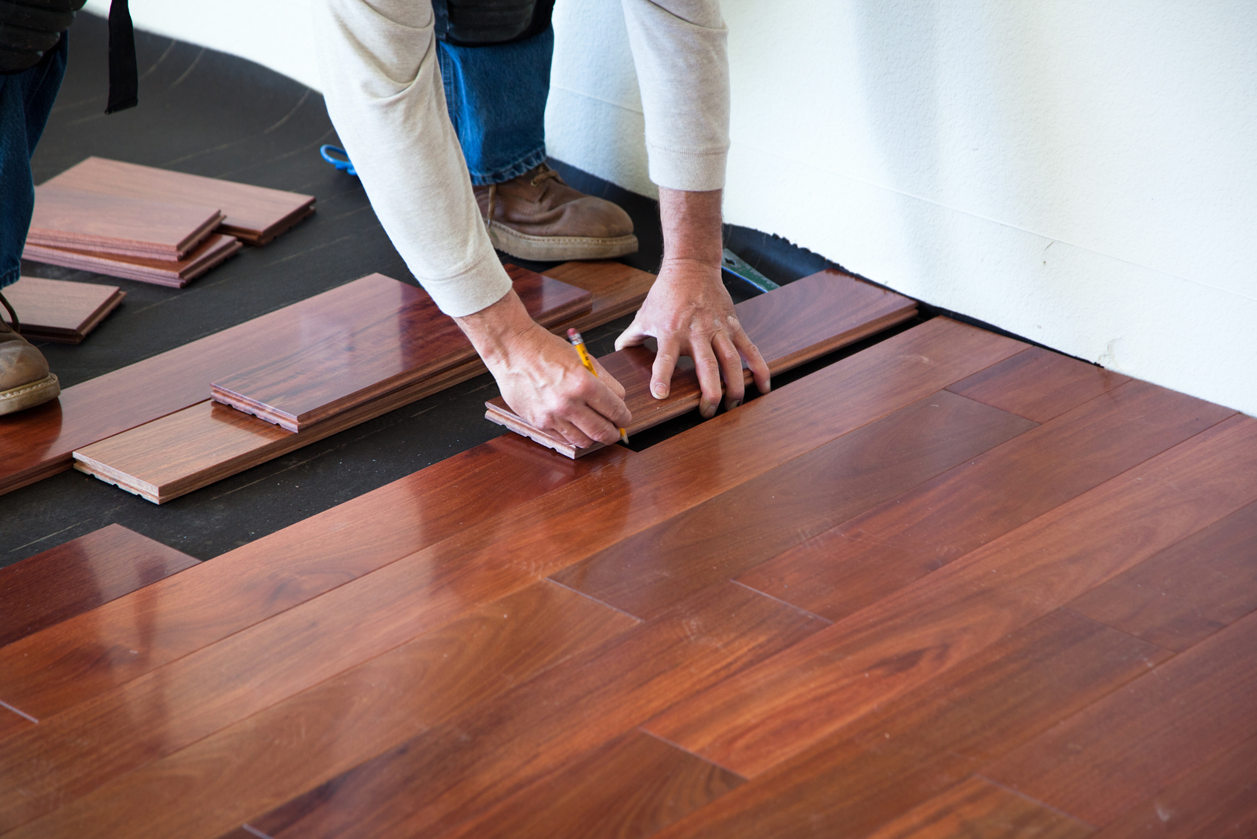 Man installing hardwood flooring.