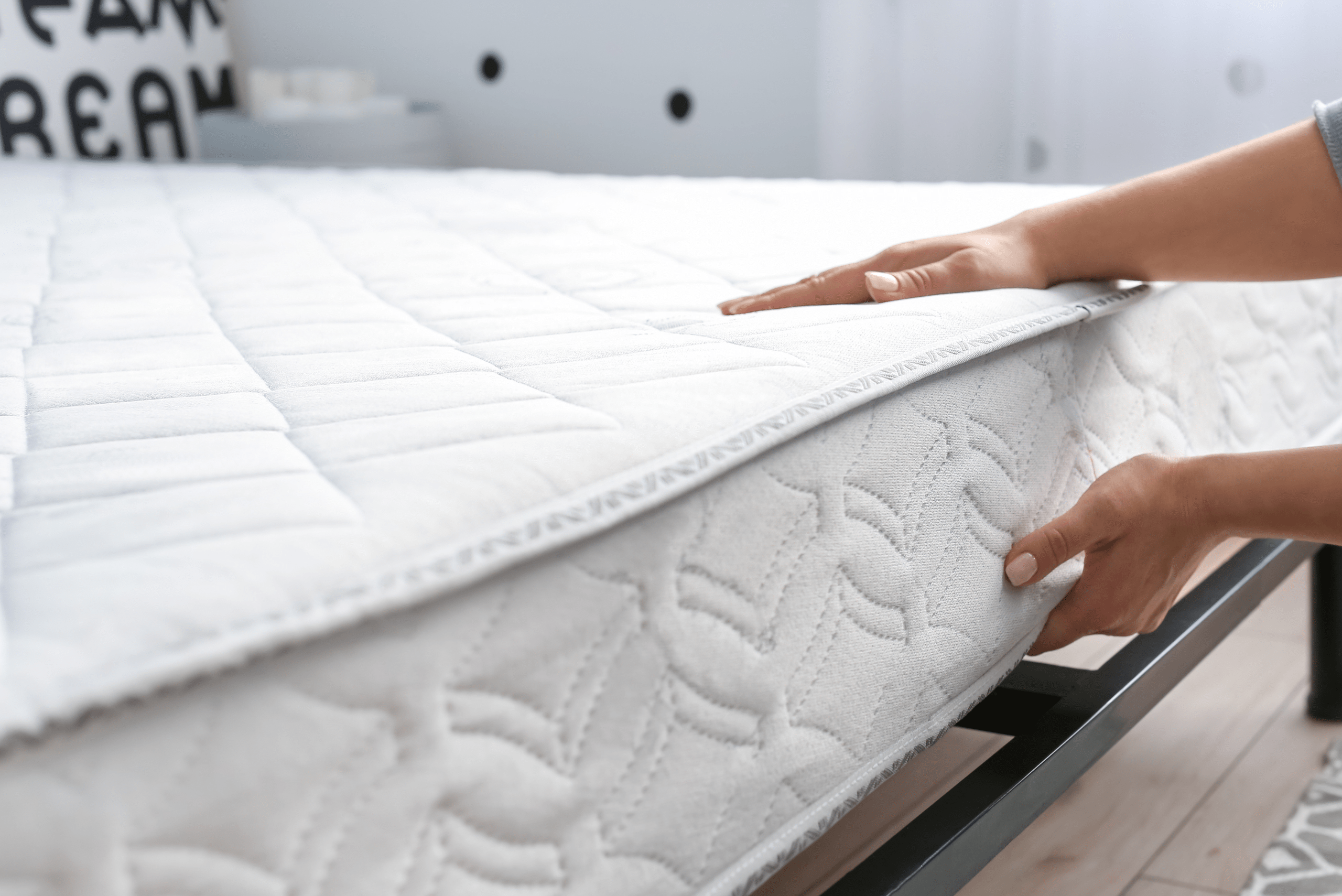 Person putting a mattress of metal bed frame.