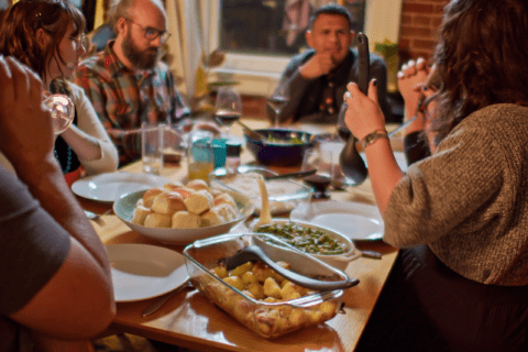 Guests enjoying a meal together on dining table.