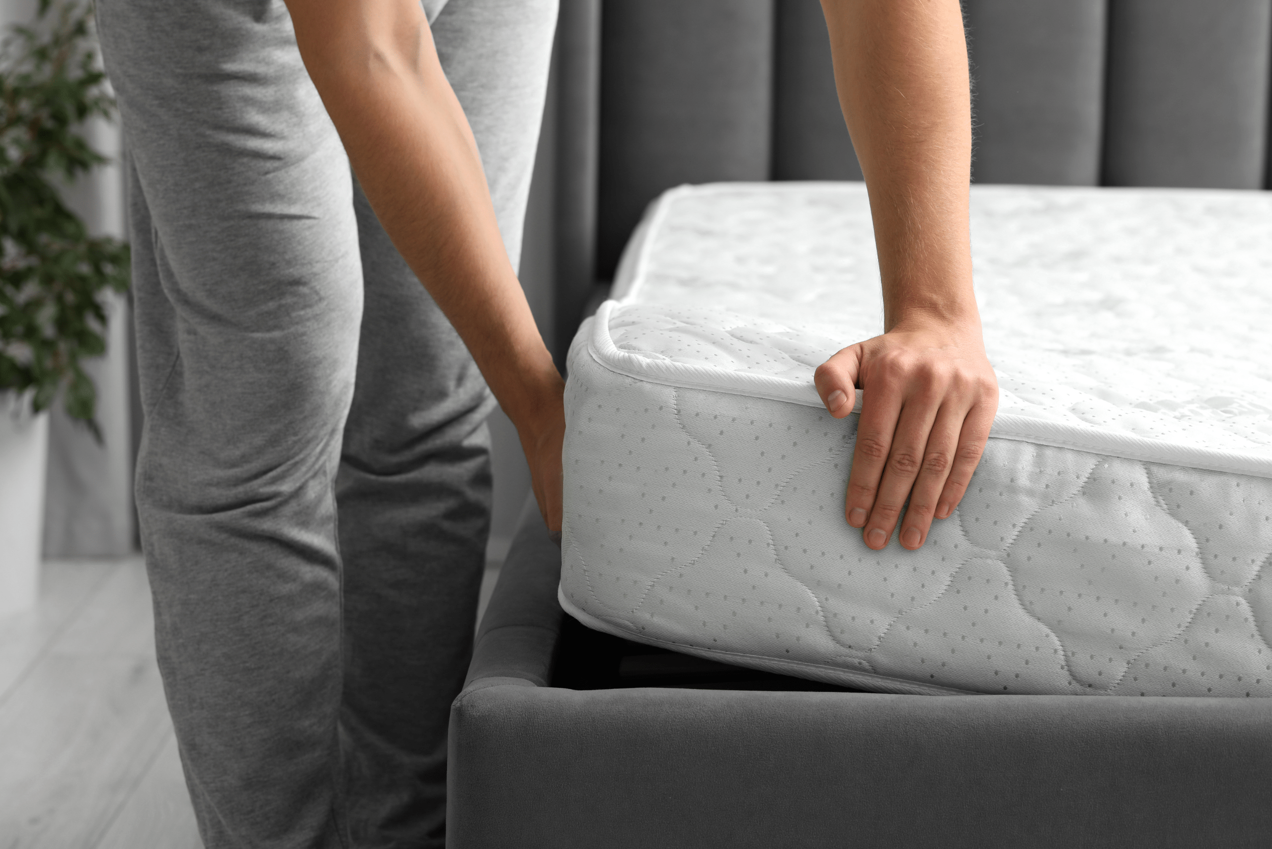 Man rotating a mattress.